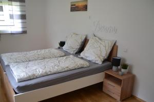 a bed with two pillows on it in a room at Zimmervermietung Familie Glatz in Möderbrugg