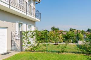 a fence in front of a house with a yard at B&B Margante in Somma Lombardo