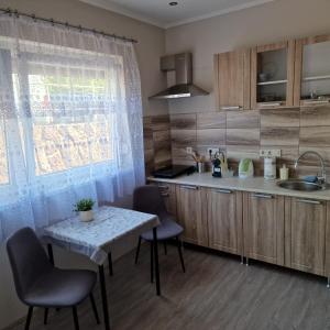 a kitchen with a table and chairs and a sink at Hanna Villa Siófok in Siófok