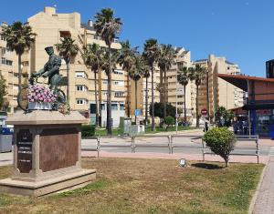 een standbeeld van een man op een fiets in een stad bij Visit Gibraltar stay in La Linea for less! in La Línea de la Concepción
