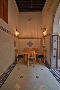 a dining room with a table and chairs at Dar Kenz Fes in Fez