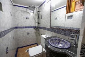 a bathroom with a sink and a toilet at Dar Kenz Fes in Fez