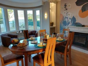a dining room with a wooden table and chairs at L'escale d'Armor in Loudéac