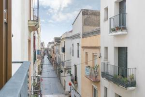 a view of an alley between two buildings at NICE CITY CENTER APARTMENT in Vilanova i la Geltrú