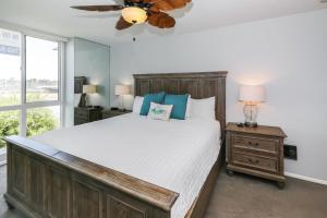 a bedroom with a large bed and a ceiling fan at G32 - Harbor Cottage - On-the-Sand in Oceanside +43 photos