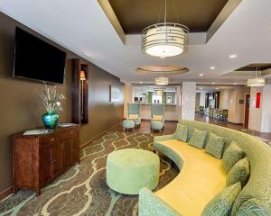 a living room with a couch and a flat screen tv at Comfort Suites near Tanger Outlet Mall in Gonzales