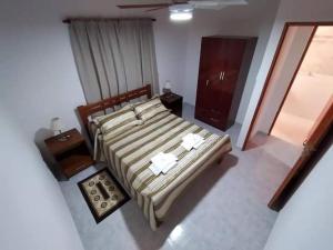 a bedroom with a large bed with two towels on it at Departamento Odi in Federación