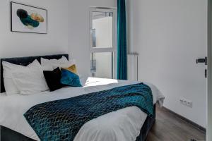 a bedroom with a bed with a blue and white comforter at Modern Apt near Old Town - King Bed - Free Parking in Poznań