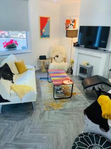 uma sala de estar com um urso de peluche e uma televisão em Funky cozy cottage with outside space em Eastbourne