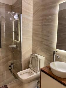 a bathroom with a toilet with a sink and a shower at Luxurious Brand New Apartment in the City Centre in Kyrenia