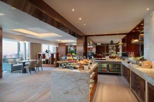 a large kitchen with a dining room and a living room at Crowne Plaza Beijing Sun Palace by IHG in Beijing