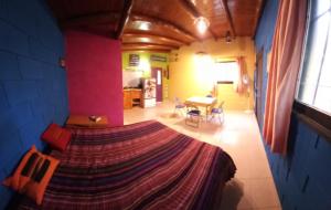 a bedroom with a large bed in a room at Casita de Colores in Cosquín