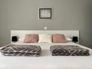 een wit bed met twee kussens erop bij Emanuela 2 in Novalja
