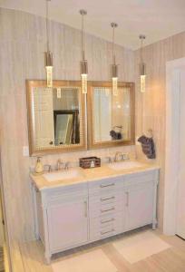a bathroom with a sink and two mirrors at New Modern house?A mins to Hwy i-85, 316 in Lawrenceville