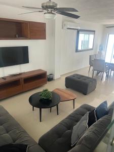 a living room with a couch and a flat screen tv at Casa Nuevo Vallarta + 2 albercas in Nuevo Vallarta