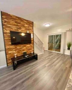 a living room with a flat screen tv on a wall at New Modern house?A mins to Hwy i-85, 316 in Lawrenceville