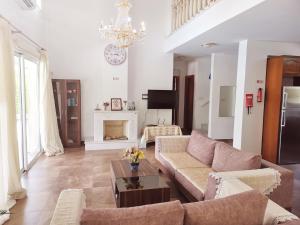 a living room with a couch and a table at Villa14 Sea Breeze in Khlorakas