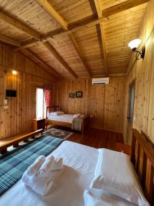 a bedroom with a bed in a wooden room at Blen Grand in Berat