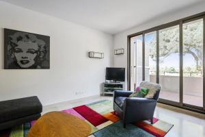 Televízia a/alebo spoločenská miestnosť v ubytovaní Appartement Mésangia - Welkeys
