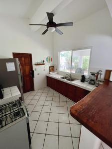 a kitchen with a ceiling fan and a counter top at Villa Montana in Contadora