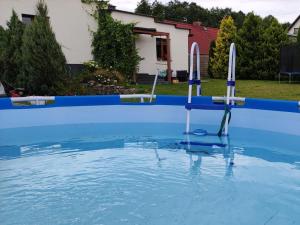 een zwembad met een blauw zwembad bij Baza Lipusz in Lipusz
