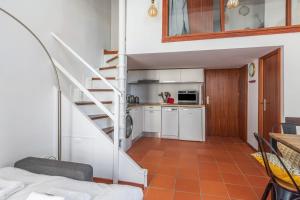 a room with a staircase leading to a kitchen at Very nice duplex located on the main square - Toulouse - Welkeys in Toulouse