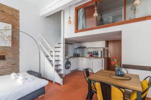a small apartment with a dining table and a kitchen at Very nice duplex located on the main square - Toulouse - Welkeys in Toulouse