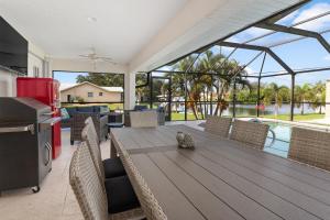 a kitchen and dining room with a table and chairs at Punta Paradise- Enjoy a 4 bedroom pool home in Punta Gorda