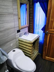 a bathroom with a toilet and a sink at Cabaña Kosta Azul Capurganá in Capurganá