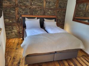 a bedroom with a bed with two white pillows at Haus zur Heugabel in Kesten