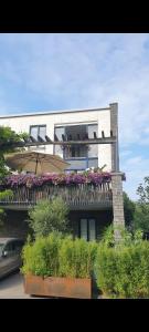 a building with a balcony with flowers on it at Lovely 1 bedroom apartment with garden in Amsterdam