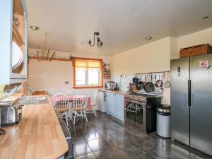 a kitchen with stainless steel appliances and a table at St Kilda in Balranald