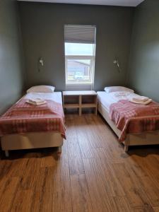 Postel nebo postele na pokoji v ubytování West Ranga lodge