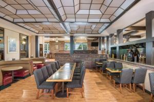 a restaurant with tables and chairs and a bar at SureStay Plus Hotel by Best Western Reno Airport in Reno