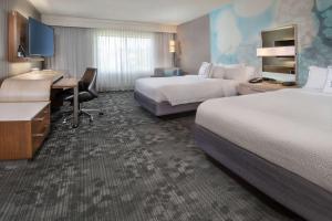 a hotel room with two beds and a desk at Sonesta Select Allentown Bethlehem Airport in Allentown