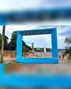 a sign for a monument in a park at Hostel el Amanecer in Puerto Iguazú