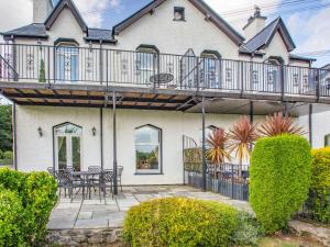 a house with a deck and a patio at Menai View in Llanfairpwllgwyngyll