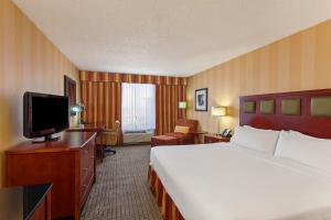 a hotel room with a bed and a flat screen tv at Holiday Inn Sacramento Downtown-Arena by IHG in Sacramento