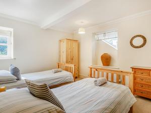 a bedroom with two beds and a window at Menai View in Llanfairpwllgwyngyll