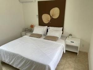 a bedroom with a large white bed with two pillows at Villa Susanna 3 bedroom 2 bathroom house sleeps 6Plus in Willemstad