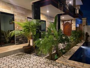 a house with a swimming pool and plants in it at Odadi Guesthouse in Dalung