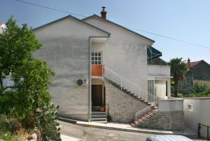 a white house with stairs in front of it at Apartments with a parking space Selce, Crikvenica - 5366 in Selce