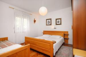 a bedroom with two beds and a window at Apartments with a parking space Selce, Crikvenica - 5366 in Selce