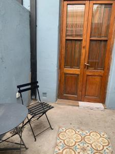 a table and a chair in front of a door at 11 de abril. Loft in Bahía Blanca