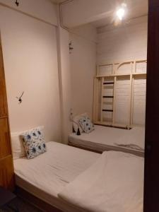 two beds in a room with two bunk beds at Silla House in Hat Yai