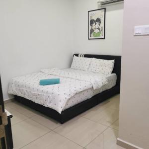 a bed with a black frame in a room at Ourstay Nadi Kota in Bandar  Pusat Jengka