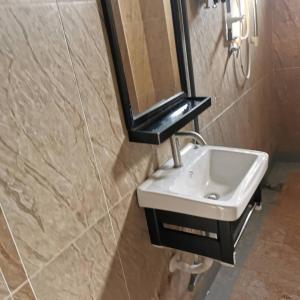 a bathroom with a sink and a mirror on the wall at Ourstay Nadi Kota in Bandar  Pusat Jengka