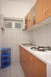 a kitchen with a sink and a stove at Apartments with a parking space Gradac, Makarska - 6757 in Gradac