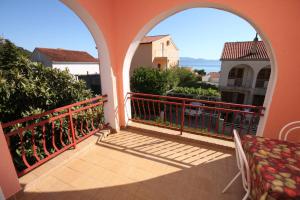 a balcony with two arches and a bench on a balcony at Apartments with a parking space Gradac, Makarska - 6757 in Gradac