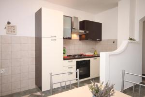 a kitchen with white cabinets and a stove at Apartments with a parking space Maslenica, Novigrad - 6548 in Jasenice